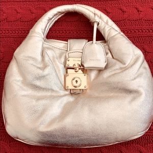 Color: Gold, Style: Top Handle, Size: 11inches tall, 11inches wide.   New